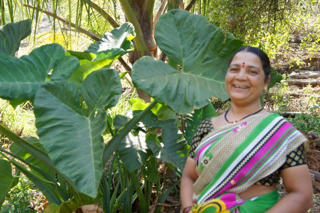 A forest home gardener in her garden
